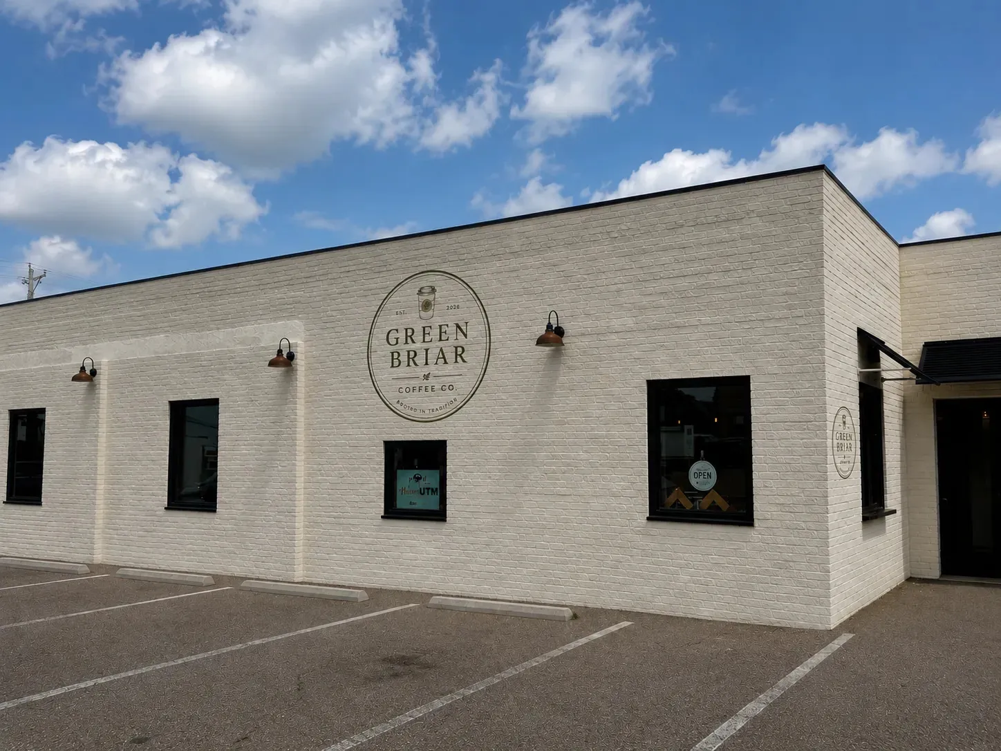 Corner of the Green Briar Coffee Co. building with the logo painted on the brick