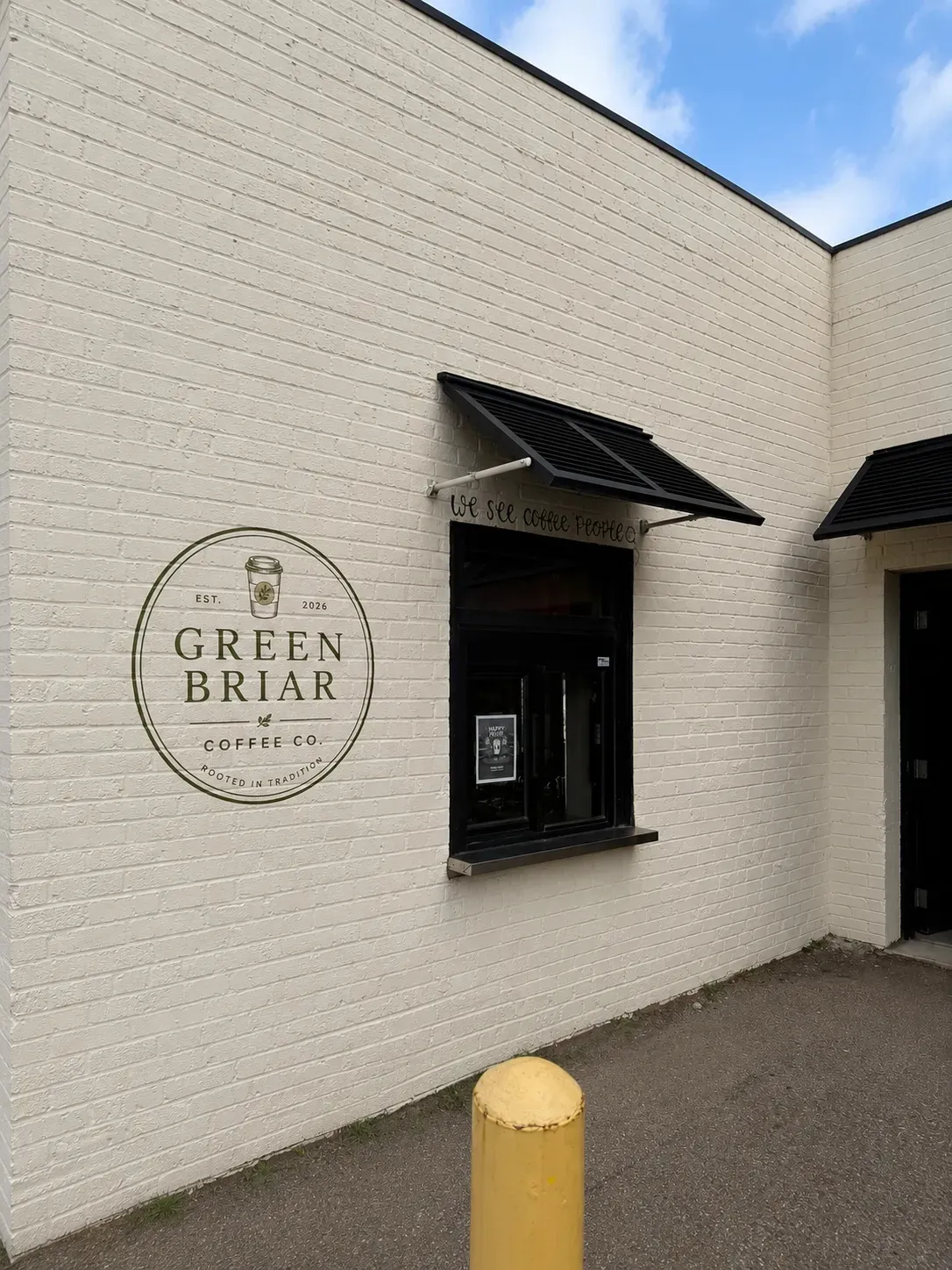 The Green Briar Coffee Co. order window, with the logo painted on the brick beside it
